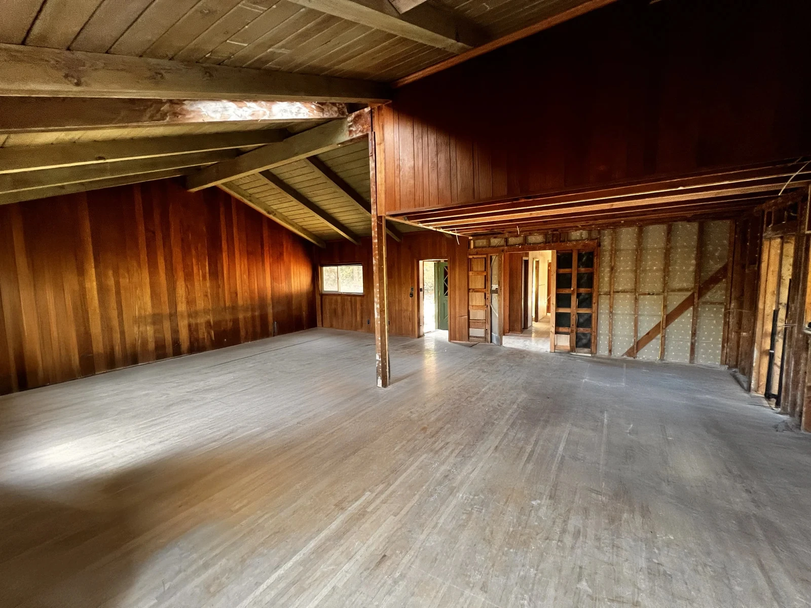 The living and dining room after demolition, framing exposed
